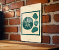 Coastal Sand Dollar & Sea Glass Metal Sign – Beach House Wall Art, Nautical Stamp Style Decor for Ocean Lovers — photo 1