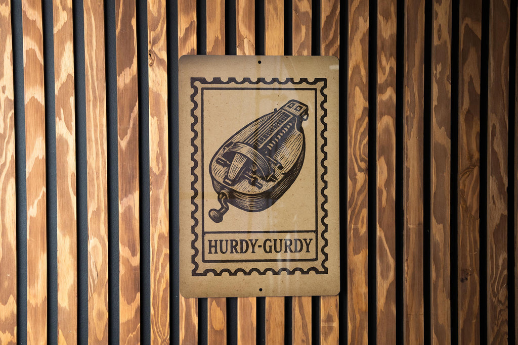 Hurdy-Gurdy Stamp Style Metal Sign – Vintage Music Instrument Wall Art, Rustic Musician Decor, Folk Music Gift — photo 1