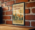 Huntsville Alabama Metal Sign Featuring Retro Postage Stamp Design with Rocket, Stars, and City Skyline Scene — photo 1