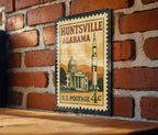 Huntsville Alabama Metal Sign Featuring Retro Postage Stamp Design with Rocket, Stars, and City Skyline Scene — photo 1