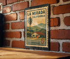 La Mirada California Metal Sign – Retro Postage Stamp Design Featuring City Name and Scenic Local Elements — photo 1