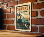 Sparks Nevada Metal Sign Featuring Retro Postage Stamp Design with Trains, Mountains, and Vintage Cityscape — photo 3