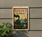 Sparks Nevada Metal Sign Featuring Retro Postage Stamp Design with Trains, Mountains, and Vintage Cityscape — photo 5