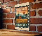 Wheat Ridge Colorado Metal Sign – Retro Postage Stamp Design Featuring Cityscape and Mountain Scene — photo 1